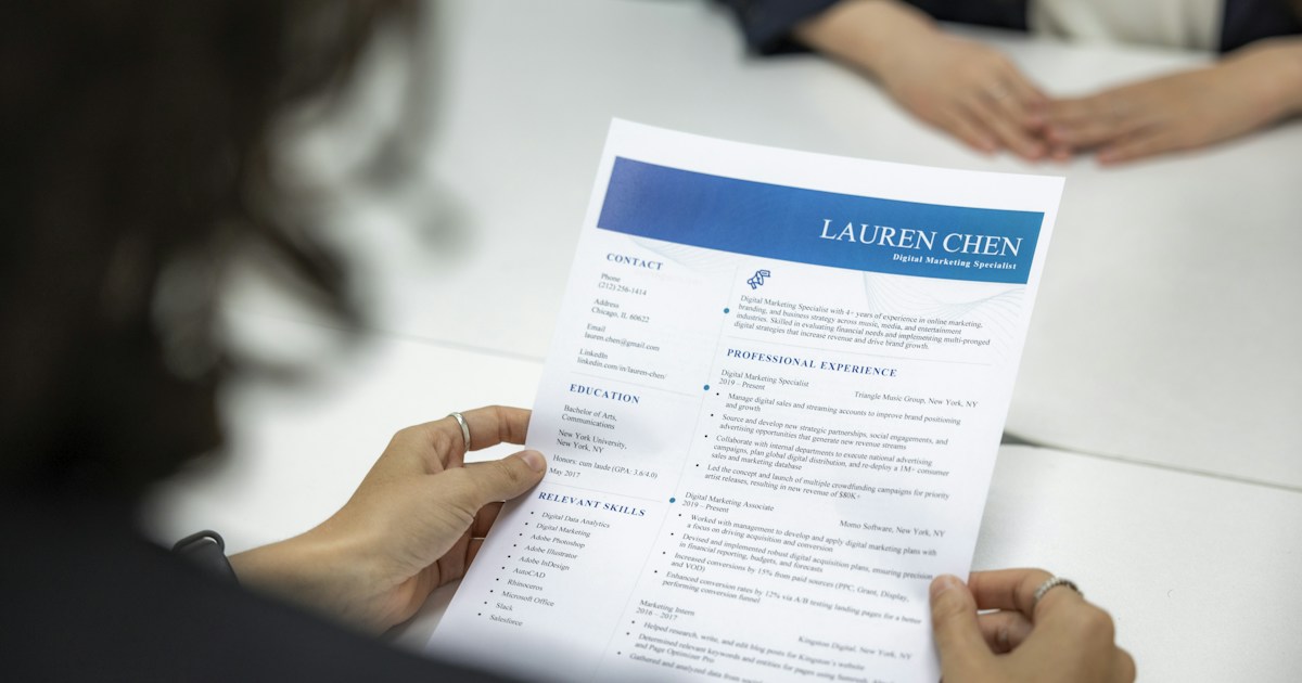 A recruiter reviewing a printed resume during an interview